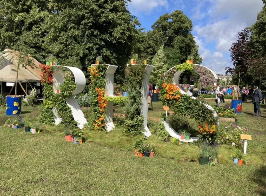 a floral display at chelsea flower show, spelling out the letters RHS