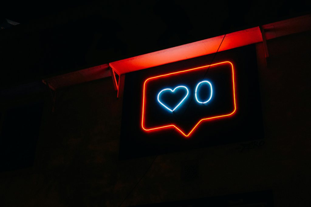 neon sign of the instagram like button with 0 likes