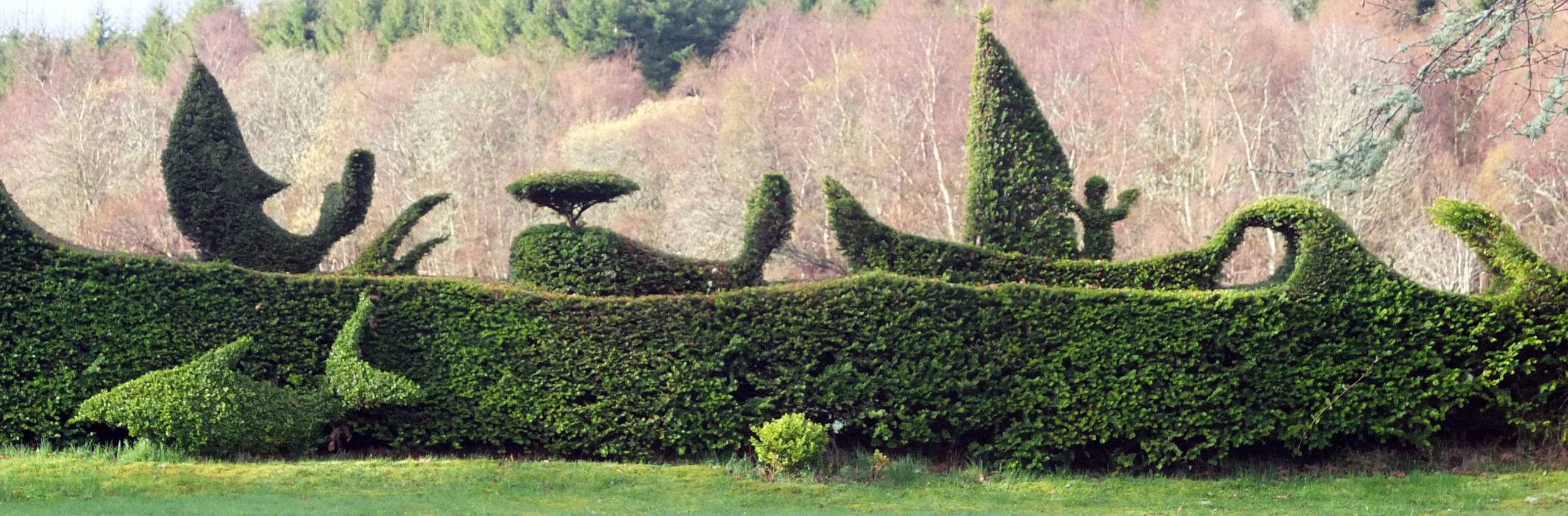 Topiary of a moby dick scene as seen from the garden.